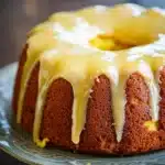 Close-up of a delicious lemon cake with a slice cut out, showcasing its moist texture.