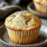 Close-up of a lemon poppyseed muffin sourdough with a golden crust and poppy seeds.