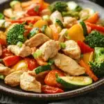 Close-up of a low calorie chicken and vegetables dish with bright colors and clean presentation.