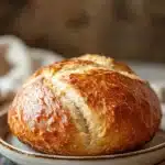 Close-up of no knead sweet bread with a golden crust on a clean background