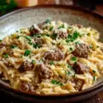 Close-up of one pot creamy orzo and beef with a warm, appetizing presentation