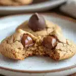 Close-up of peanut butter Hershey kiss cookies on a white plate with a clean background