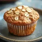 Close-up of a protein muffin with visible textures and natural lighting