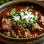 Close-up of slow cooker beef birria with rich textures and vibrant colors
