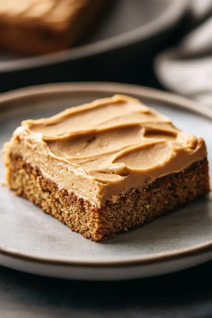 Close-up of a taste of home peanut butter zucchini sheet cake with a creamy topping