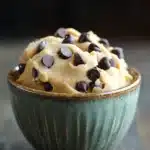 Close-up of keto edible peanut butter cookie dough in a bowl with a spoon