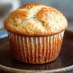 Close-up of freshly baked muffins made with kodiak muffin mix and greek yogurt, showcasing their golden brown tops.