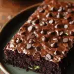 Close-up of zucchini sheet cake brownies with a light, moist texture and a clean background.